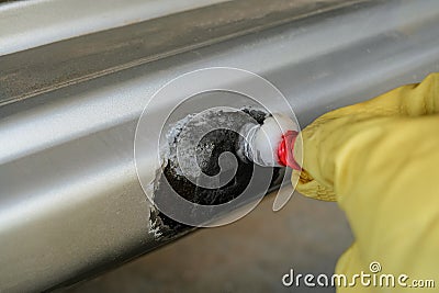 Electrochemical electroplating with zinc in domestic conditions to part being repaired of damaged galvanized car body Stock Photo