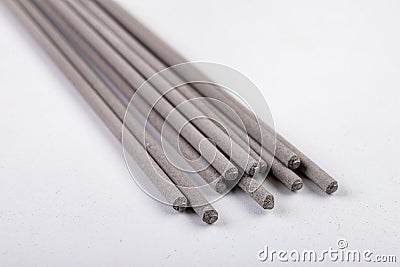 Electrodes for electric welding on a white workbench. Welding accessories for MMA methods Stock Photo