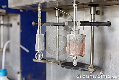 Electrolysis of copper sulfate in lab. It takes place in an electrolytic cell where electrolysis Stock Photo