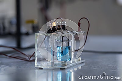 Electrolyte solution turns on a light bulb. Experiment in the chemistry laboratory Stock Photo