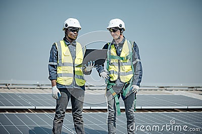 Electromechanical solar panel technician install, assemble photovoltaic systems on roof based on site assessment and schematic Stock Photo