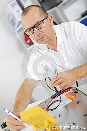 Electromechanical technician inspecting appliance Stock Photo