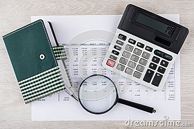 Electronic calculator, magnifying glass and notepad with pen on Stock Photo