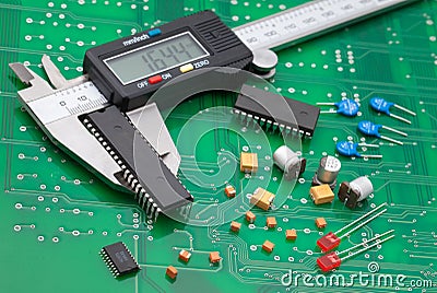 Electronic caliper measure IC and electronic part on green pcb Stock Photo