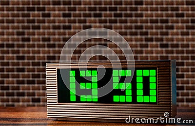 Electronic clock on the surface on a brick wall background Stock Photo