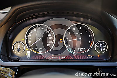 Electronic dashboard of modern luxury car with electronic display and with white arrows speedometer tachometer and other tools Stock Photo