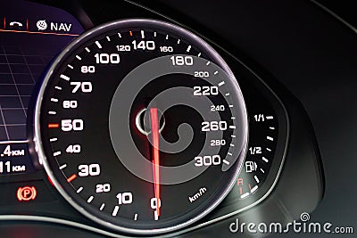 Electronic dashboard of modern luxury car view from aside. Speedometer shows speed in kilometers per hour and fuel Stock Photo