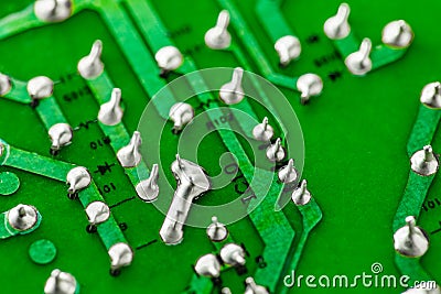 Electronic green printed circuit board with soldered copper tin contacts, close-up, selective focus Stock Photo