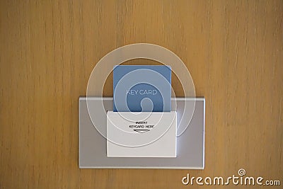 Electronic lock with key card inserted. Key card into hotel room door lock. Stock Photo