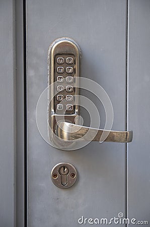 Electronic lock with numeric buttons for entering code and a handle for opening the door Stock Photo