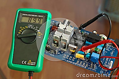 Electronic metering device multimeter showing the voltage parameter in an electronic device consisted of microchip Stock Photo