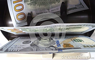 Electronic money counter machine is counting is counting the American hundred-dollar US dollars banknotes Stock Photo