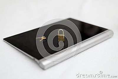 Electronic security and data protection concept. Tablet computer and lock with keys Stock Photo