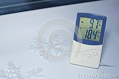 Electronic thermometer is on the windowsill Stock Photo