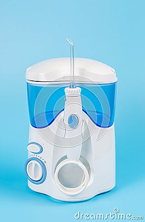 Electronic Tooth Irrigator for personal home usage on blue background Stock Photo