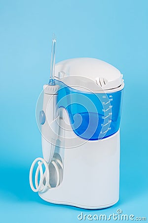 Electronic Tooth Irrigator for personal home usage on blue background Stock Photo