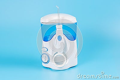 Electronic Tooth Irrigator for personal home usage on blue background Stock Photo