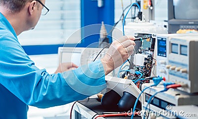 Electronics engineer troubleshooting defects in a hardware product Stock Photo