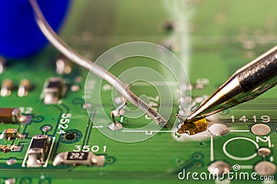 Electronics manufacturing services, soldering of electronic board Stock Photo