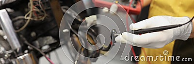 Electronics repair service master using multimeter tester to determine the problem part Stock Photo