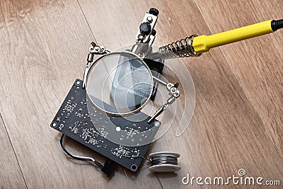 Electronics repair service, Technician fixing electronic circuit board with soldering iron and tin Stock Photo