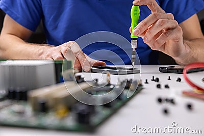 Electronics repair service. technician working in office. repairing phone Stock Photo