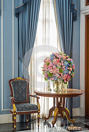 Elegance armchair and flower bouquet on table Stock Photo