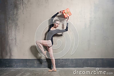 Elegance ballerina holding gift box above head Stock Photo