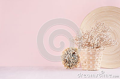 Elegance home eco decor - white dried flowers bouquet in basket with decorative plate, bunch sticks on fashion pink background. Stock Photo