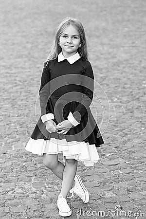 Elegance that you deserve. Little child wear uniform dress outdoors. Back to school fashion. Fashion look of small girl Stock Photo