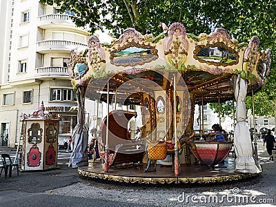 Antique carousel running in a French square Editorial Stock Photo