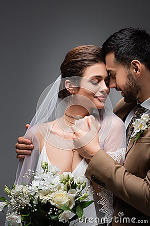 elegant arabian man embracing happy bride Stock Photo