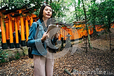 Elegant asian photographer holding her guidebook Stock Photo