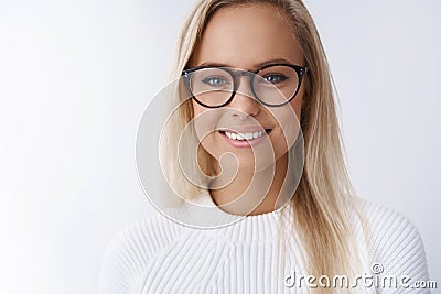 Elegant attractive young businesswoman in glasses smiling delighted, satisfied with new frame of eyewear gazing friendly Stock Photo