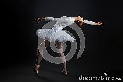 Elegant ballerina made a deflection. photo shoots in the studio on a dark background Stock Photo