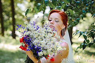 Elegant blonde bride with long hair and a bouquet of sunflowers Stock Photo