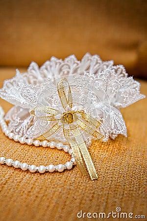 Elegant bride garter and pearls necklace Stock Photo