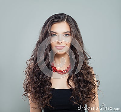 Elegant brunette woman model with makeup, curly long hair and red coral necklace Stock Photo