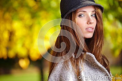 Elegant brunette woman in a park in autumn Stock Photo