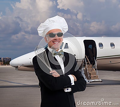 Elegant chef posing in front of a private jet Stock Photo