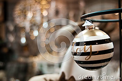 Elegant Christmas bauble with Joy word and bokeh Stock Photo