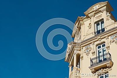 Elegant corner of classy baroque building with windows and balcony downtown Madrid, Spain Stock Photo