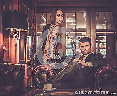 Elegant couple in luxury cabinet interior Stock Photo