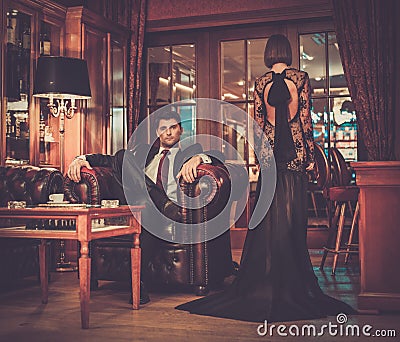 Elegant couple in luxury cabinet interior Stock Photo