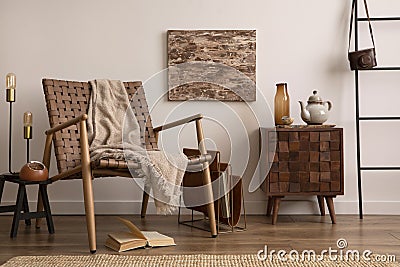 Elegant and cozy interior of living room interior with mock up poster frame, wooden comode, stylish armchair, beige plaid, book Stock Photo