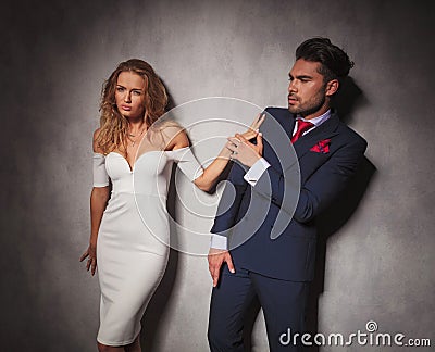 Elegant fashion man is pushed away by his lover Stock Photo