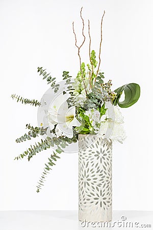 Elegant flower arrangement in beautiful vase isolated in a bright white studio Stock Photo