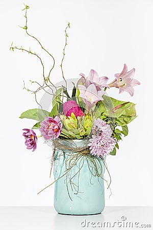 Elegant flower arrangement in beautiful vase isolated in a bright white studio Stock Photo