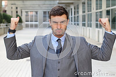 Elegant funny businessman flexing his muscles Stock Photo