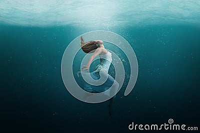 Dancer underwater in a state of peaceful levitation Stock Photo